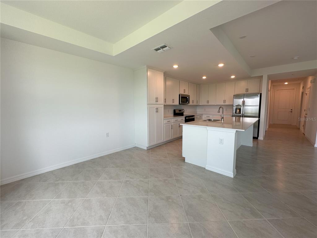 14131 Heritage Landing Boulevard, Unit 822 Punta Gorda, FL 33955 - Photo 6 of 51 a kitchen with a refrigerator and a sink