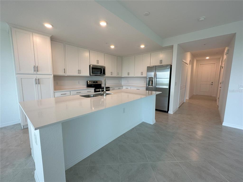 14131 Heritage Landing Boulevard, Unit 822 Punta Gorda, FL 33955 - Photo 7 of 51 a kitchen with stainless steel appliances granite countertop a refrigerator sink and cabinets