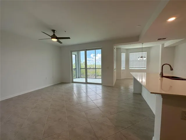 a view of empty room with ceiling fan