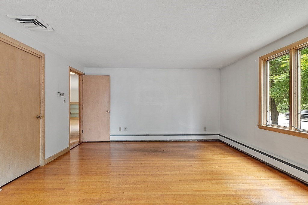 911 Main Street Reading, MA 01867 - Photo 13 of 42 a view of a room with wooden floor and a window