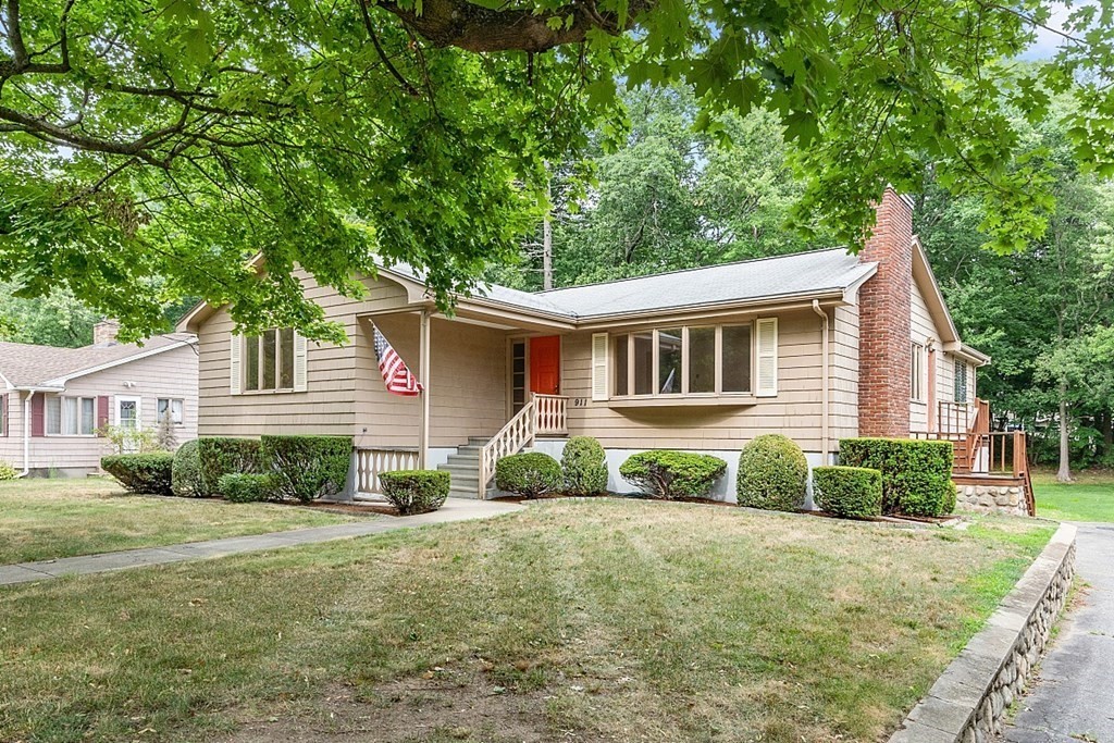 911 Main Street Reading, MA 01867 - Photo 2 of 42 a front view of a house with a yard