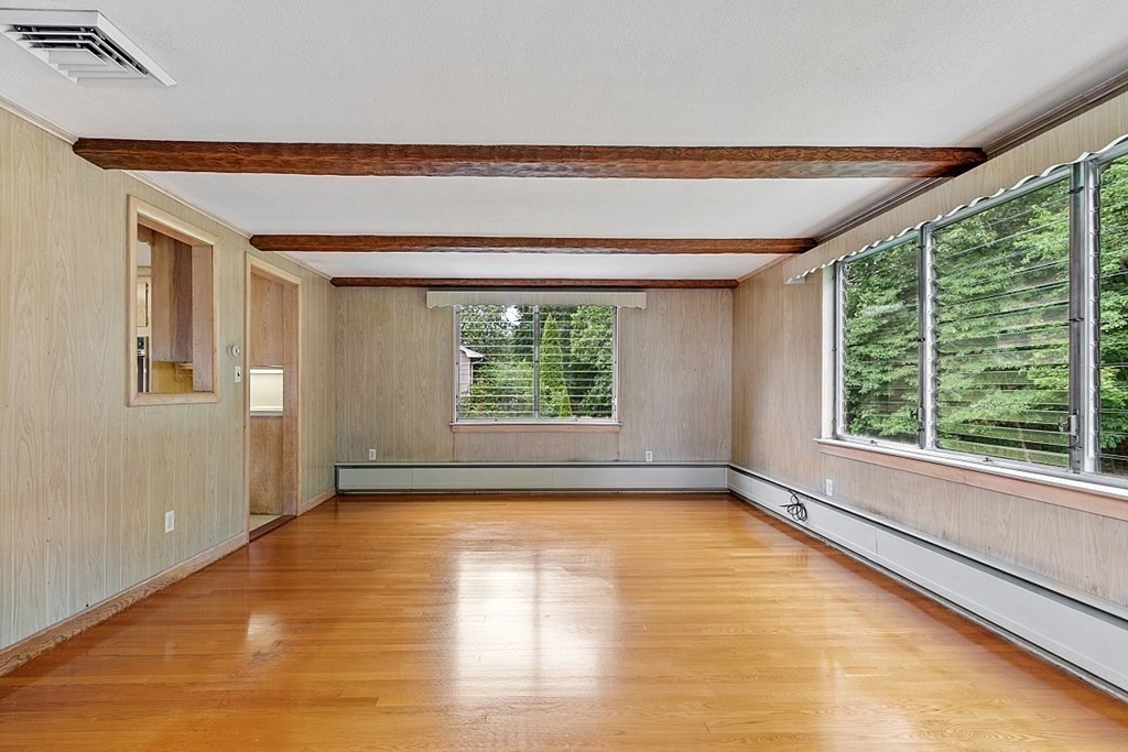 911 Main Street Reading, MA 01867 - Photo 22 of 42 a view of an empty room with a window and wooden floor