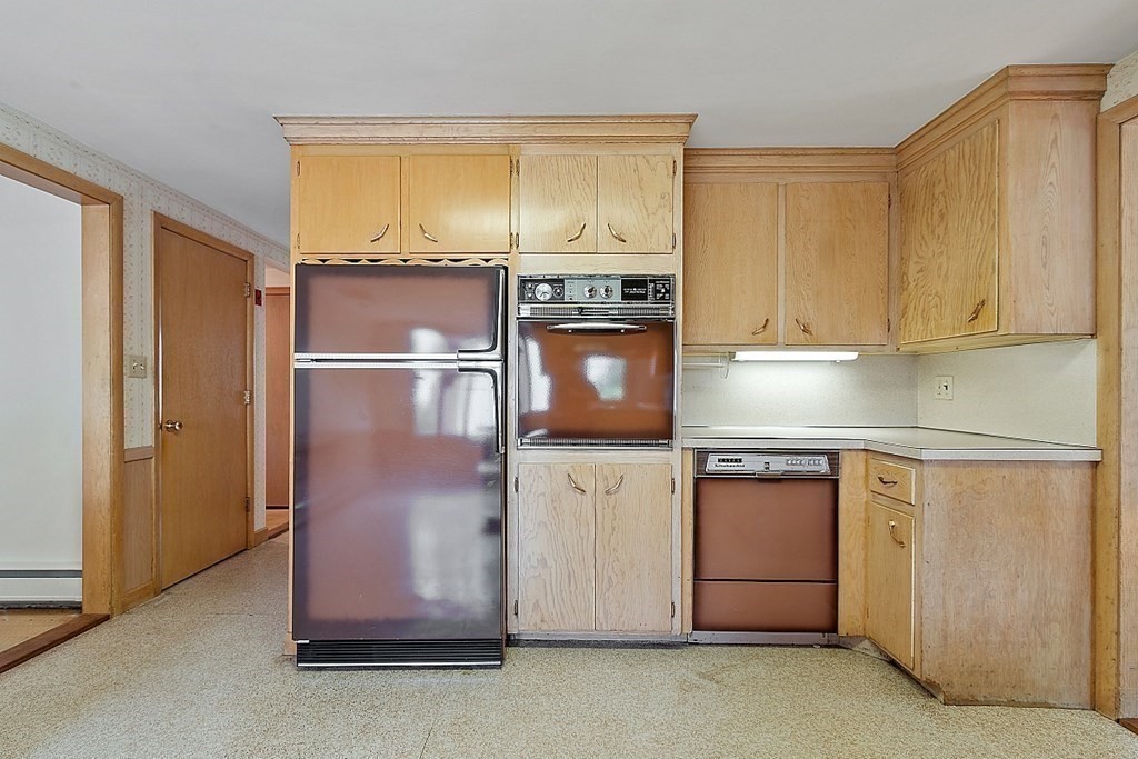 911 Main Street Reading, MA 01867 - Photo 25 of 42 a kitchen with stainless steel appliances granite countertop a refrigerator stove and microwave