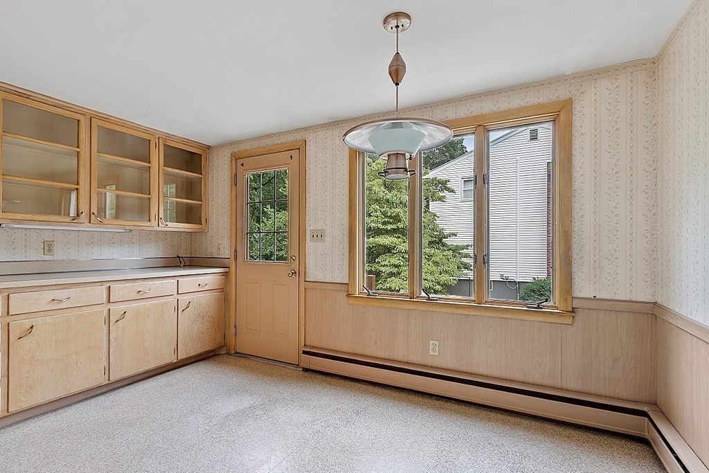 911 Main Street Reading, MA 01867 - Photo 27 of 42 a open kitchen with granite countertop a sink and a window