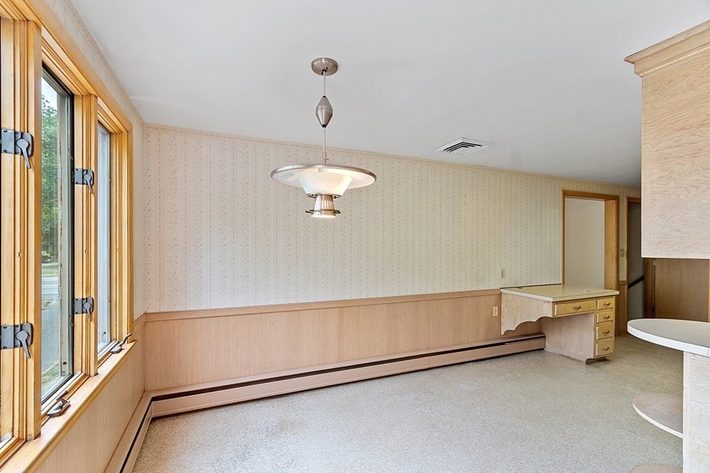 911 Main Street Reading, MA 01867 - Photo 28 of 42 a view of a room with rack on the wall and a large window