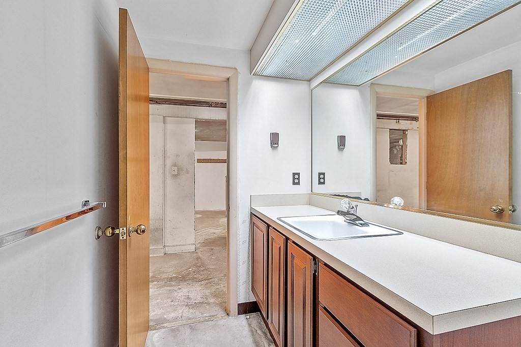 911 Main Street Reading, MA 01867 - Photo 33 of 42 a bathroom with a sink double vanity and a mirror