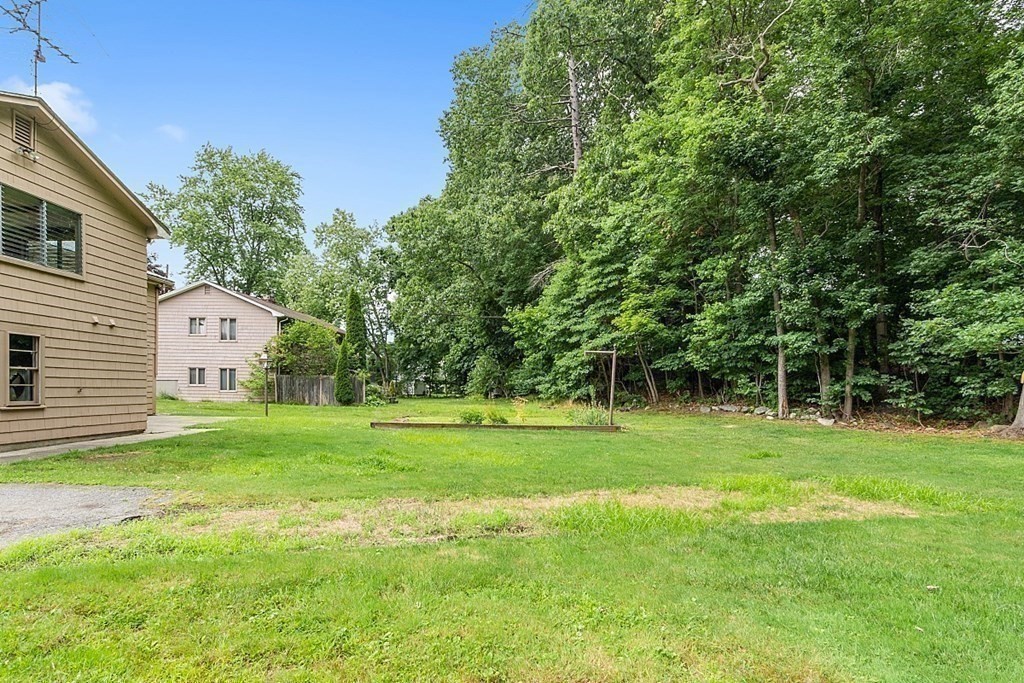 911 Main Street Reading, MA 01867 - Photo 38 of 42 a view of a backyard with a garden