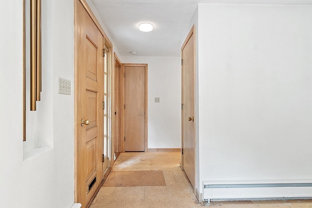 911 Main Street Reading, MA 01867 - Photo 6 of 42 a view of a hallway with wooden floor and entryway