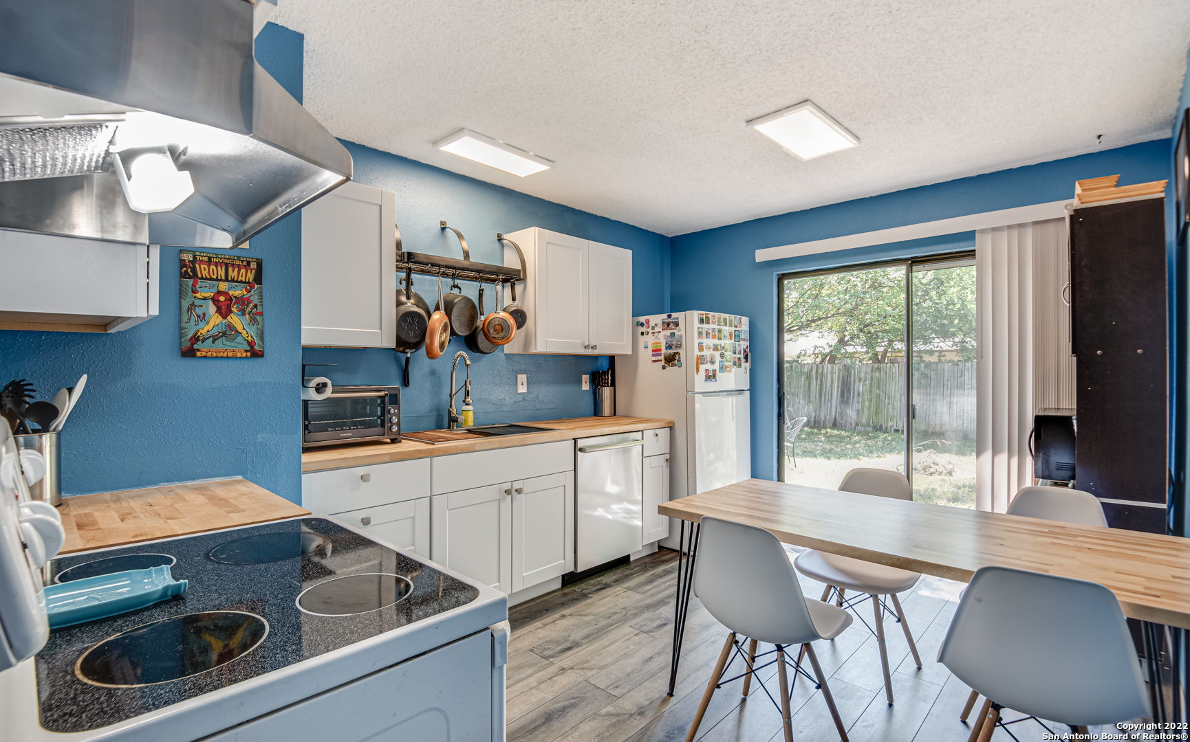 a kitchen with a stove a refrigerator and wooden cabinets