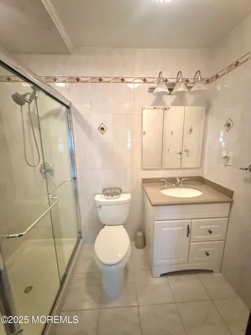 a bathroom with a sink a toilet and a shower