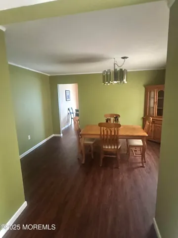 a dining room with furniture and wooden floor