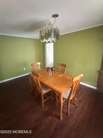 a dining room with furniture and chandelier kitchen view