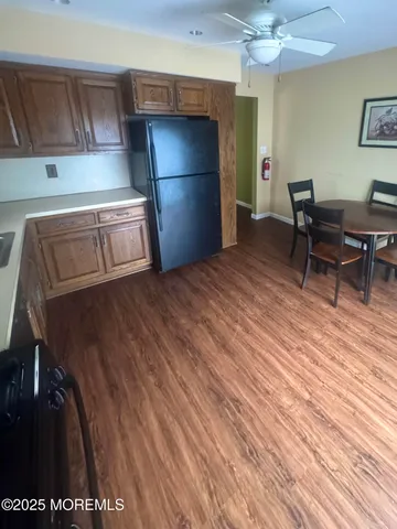 a view of a kitchen with fridge and workspace
