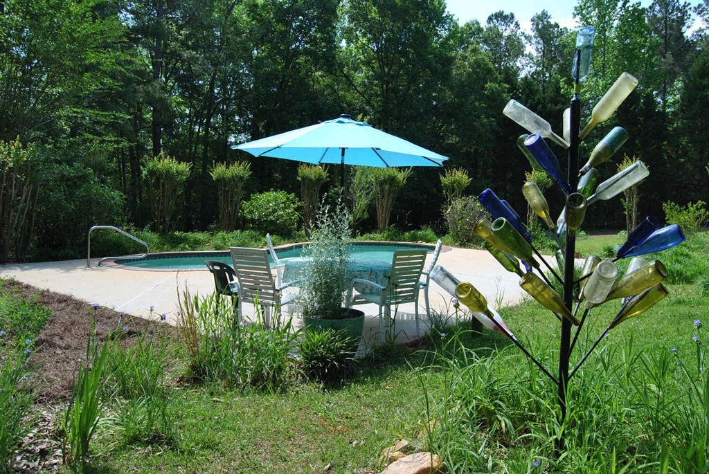 249 Bolingview Road Juliette, GA 31046 - Photo 14 of 45 a view of a lake with a bench and trees