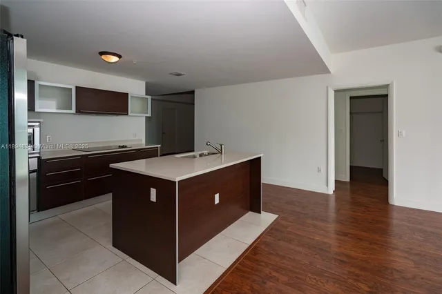 a kitchen with a sink and a stove top oven