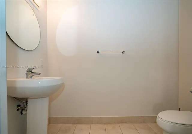 a bathroom with a sink a toilet and mirror