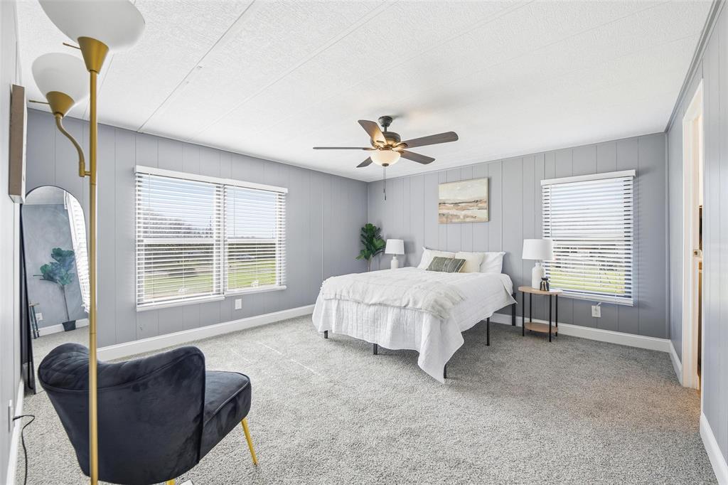 960 Pecan Street Azle, TX 76020 - Photo 18 of 34 a spacious bedroom with a bed and a couch