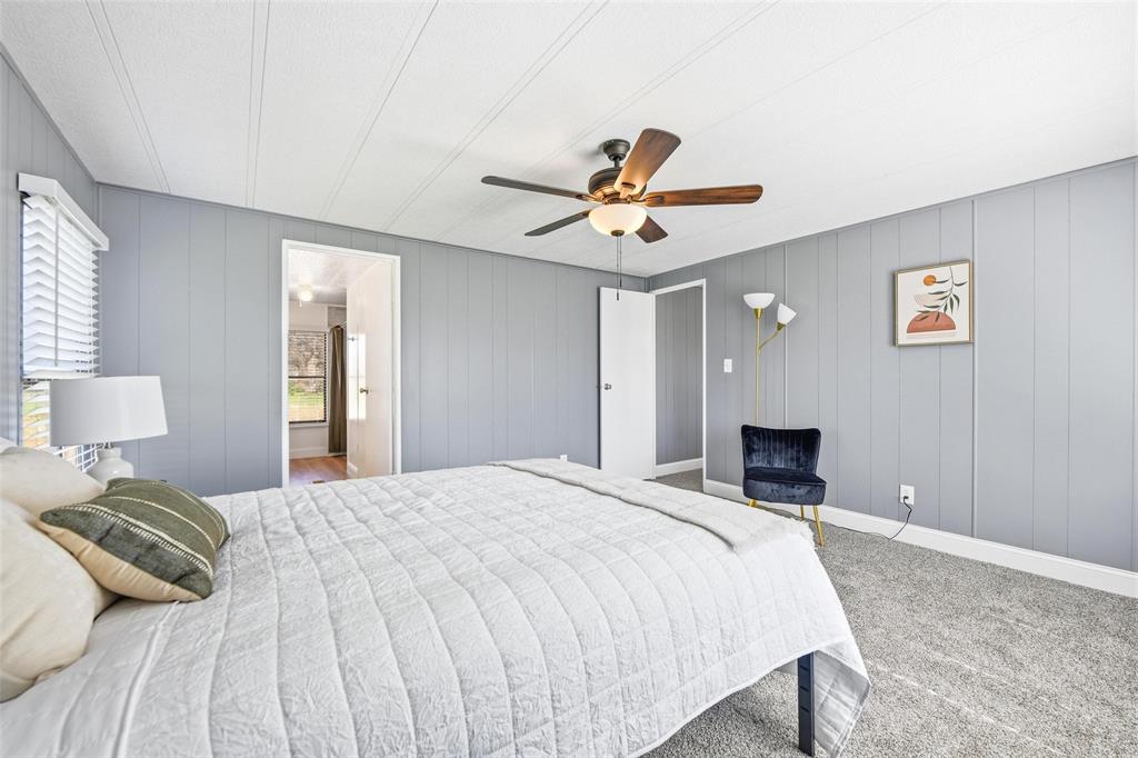 960 Pecan Street Azle, TX 76020 - Photo 20 of 34 a bedroom with a bed and a chandelier