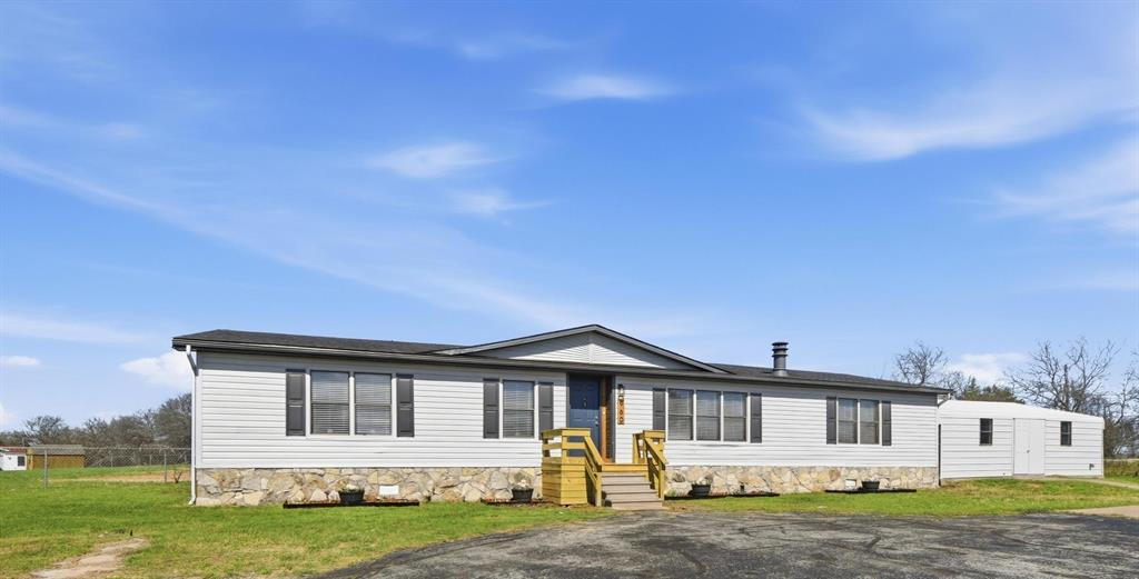960 Pecan Street Azle, TX 76020 - Photo 2 of 34 a front view of a house with a garden and yard