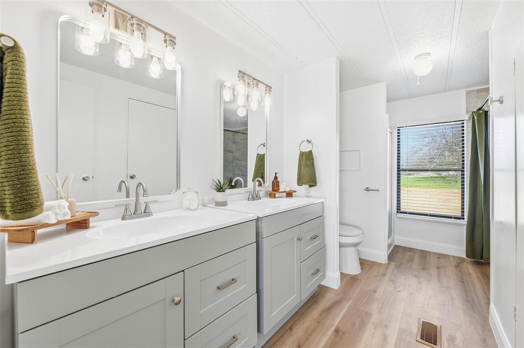 960 Pecan Street Azle, TX 76020 - Photo 21 of 34 a bathroom with a double vanity sink and a mirror