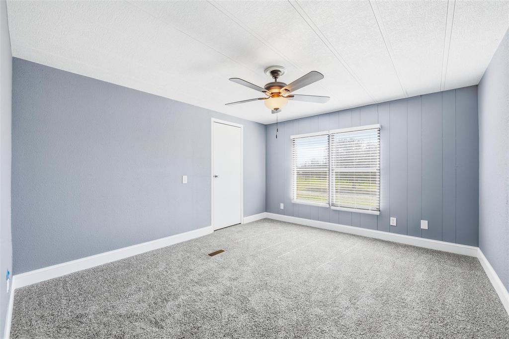 960 Pecan Street Azle, TX 76020 - Photo 23 of 34 an empty room with a window and a ceiling fan