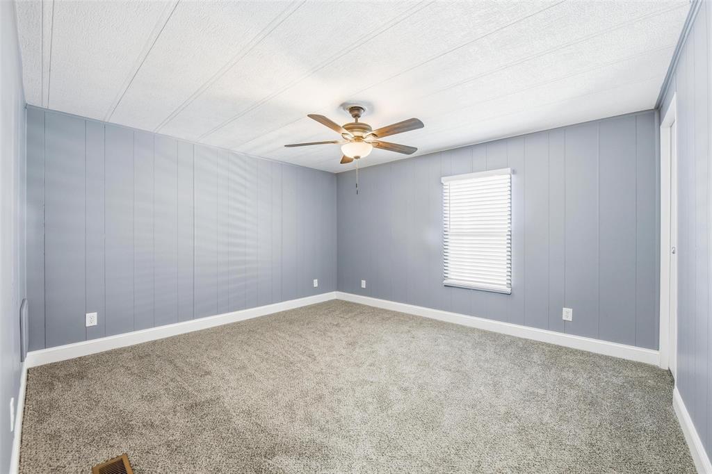 960 Pecan Street Azle, TX 76020 - Photo 24 of 34 an empty room with a window and a ceiling fan