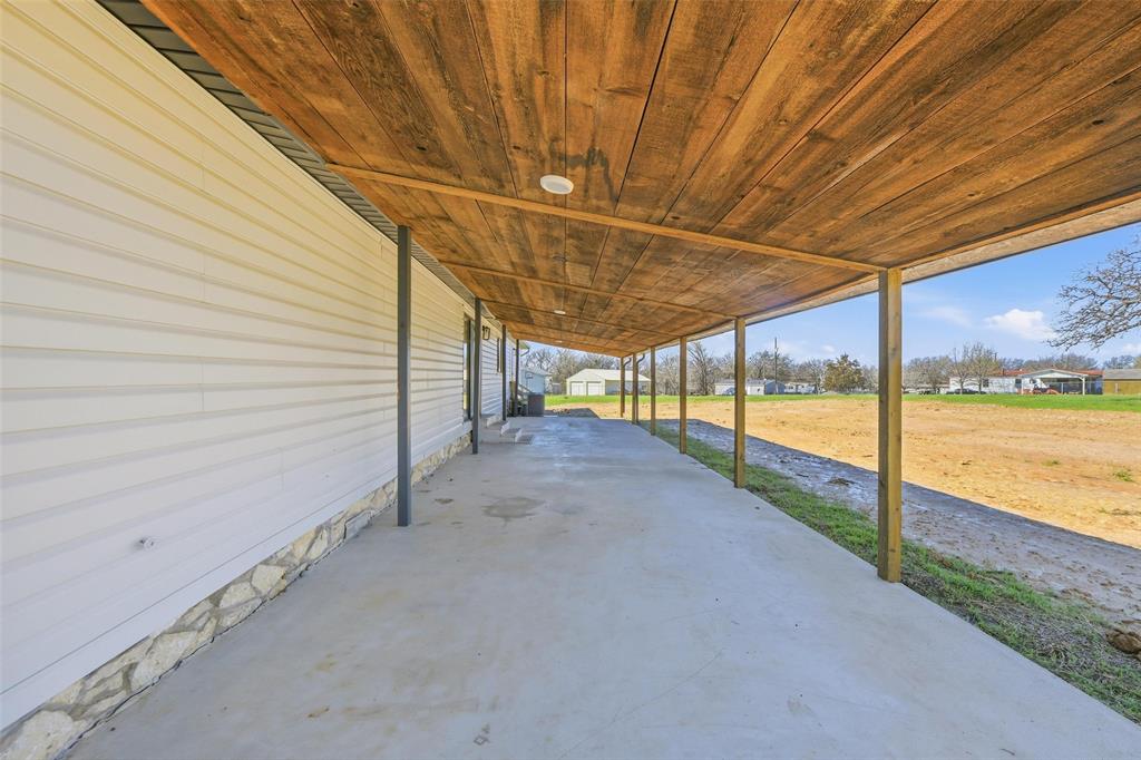 960 Pecan Street Azle, TX 76020 - Photo 26 of 34 a view of a patio with a table and chairs under an umbrella