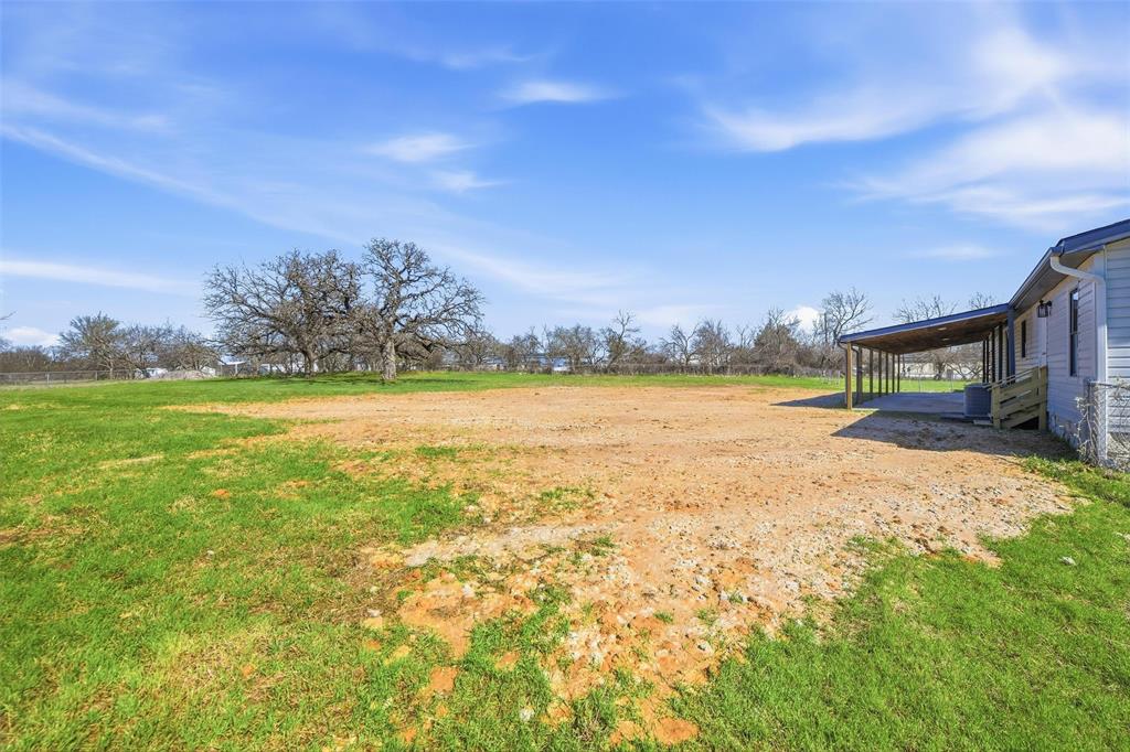 960 Pecan Street Azle, TX 76020 - Photo 29 of 34 a view of a big yard with swimming pool and an outdoor seating