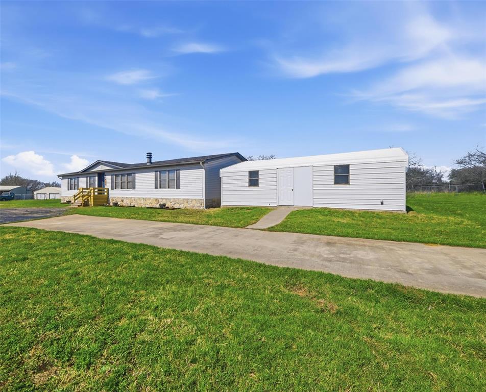 960 Pecan Street Azle, TX 76020 - Photo 3 of 34 a view of yard with swimming pool and green space