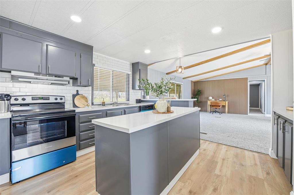 960 Pecan Street Azle, TX 76020 - Photo 9 of 34 a large kitchen with stainless steel appliances and a sink