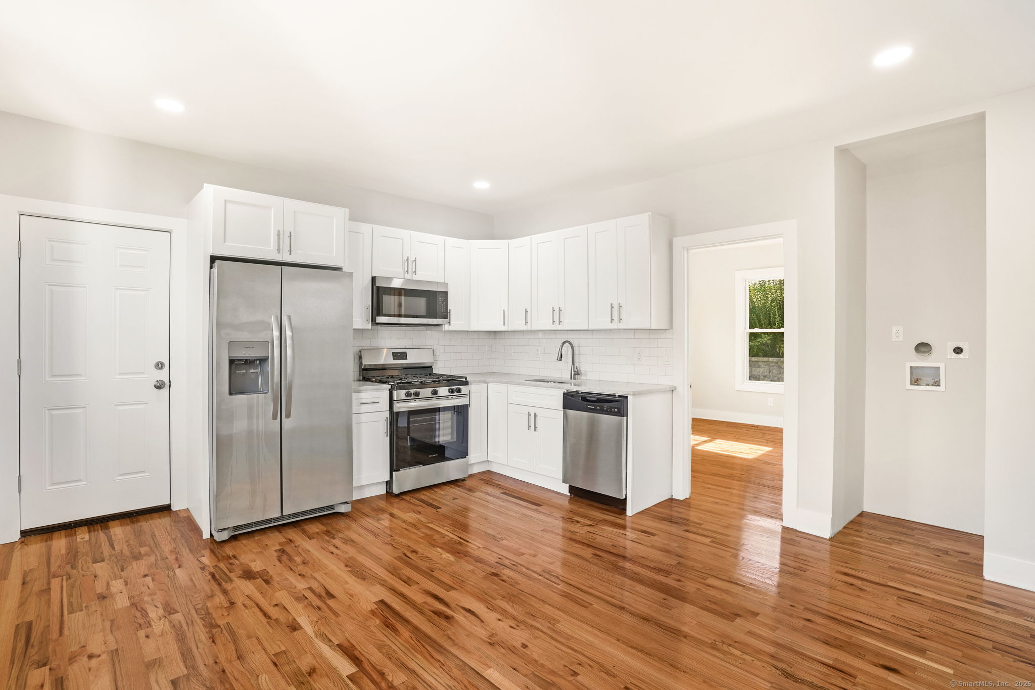 10 Perry Hill Road Shelton, CT 06484 - Photo 1 of 1 a kitchen with granite countertop a refrigerator and a stove top oven