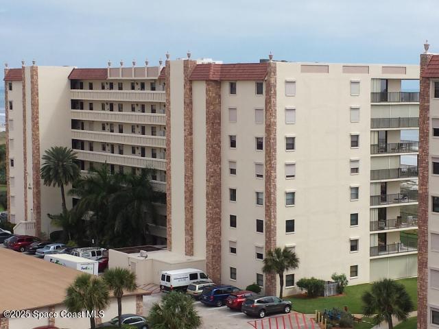 1830 North Atlantic Avenue, Unit C102 Cocoa Beach, FL 32931 - Photo 1 of 21 view of a tall building in front of a building