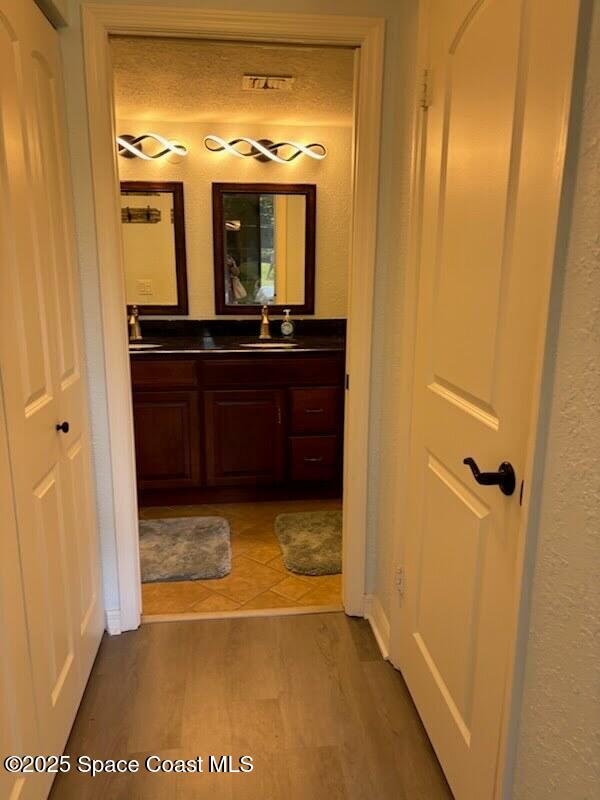 1830 North Atlantic Avenue, Unit C102 Cocoa Beach, FL 32931 - Photo 11 of 21 a view of a bathroom from a hallway