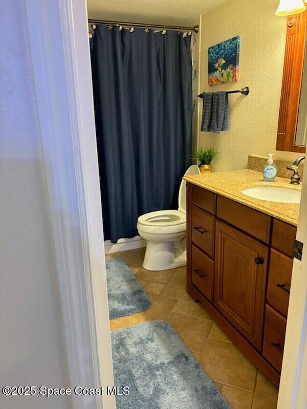 1830 North Atlantic Avenue, Unit C102 Cocoa Beach, FL 32931 - Photo 12 of 21 a bathroom with a sink a toilet and vanity