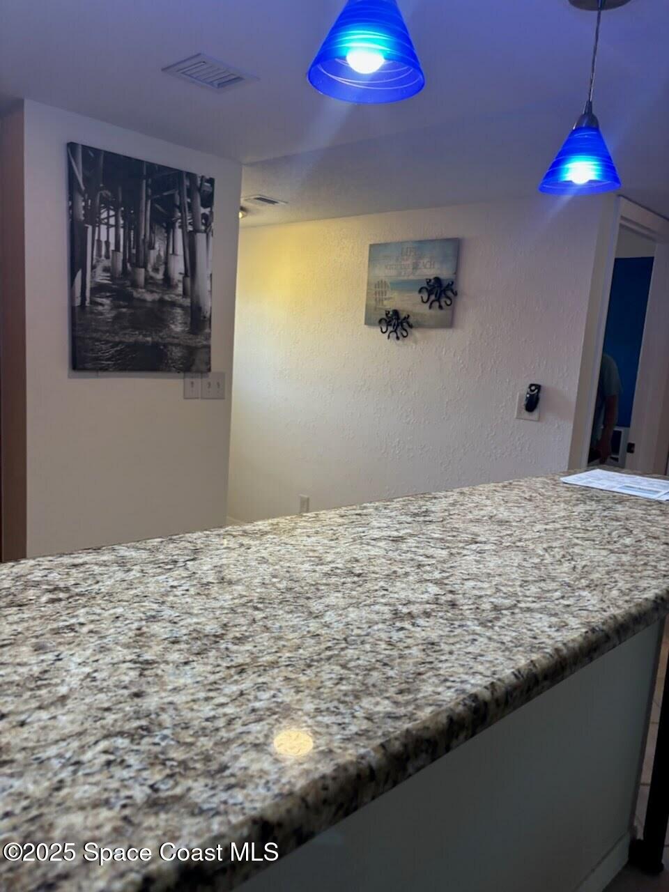 1830 North Atlantic Avenue, Unit C102 Cocoa Beach, FL 32931 - Photo 7 of 21 a view of a hall with a fireplace