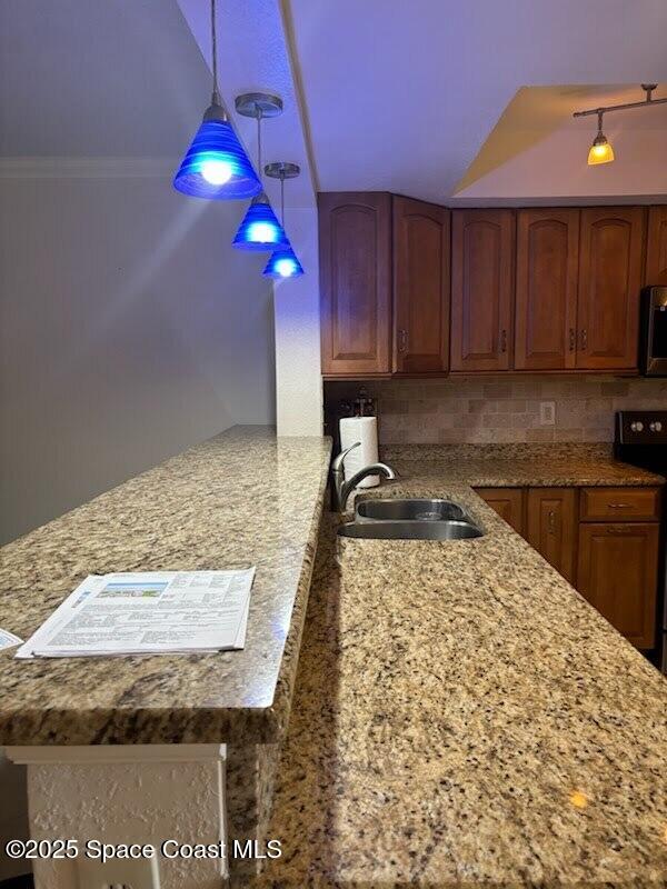 1830 North Atlantic Avenue, Unit C102 Cocoa Beach, FL 32931 - Photo 8 of 21 a kitchen with a stove a sink and a wooden cabinets