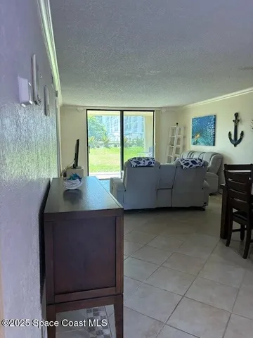 a living room with furniture a window and a flat screen tv