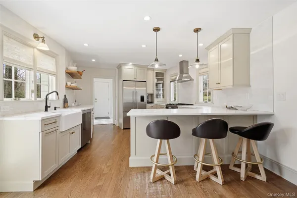 a kitchen with stainless steel appliances kitchen island granite countertop a stove a sink and a refrigerator