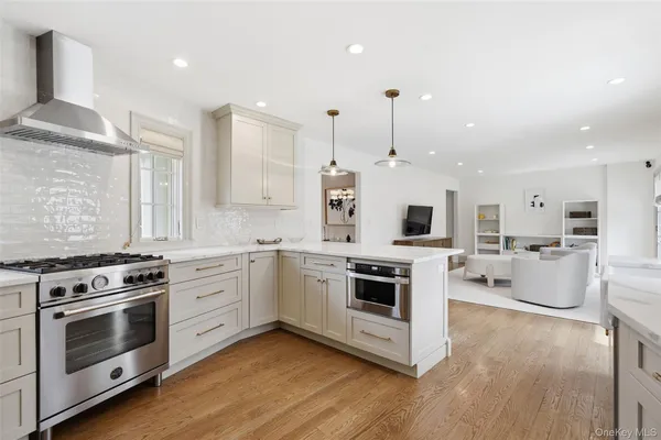 a kitchen with a stove and white cabinets