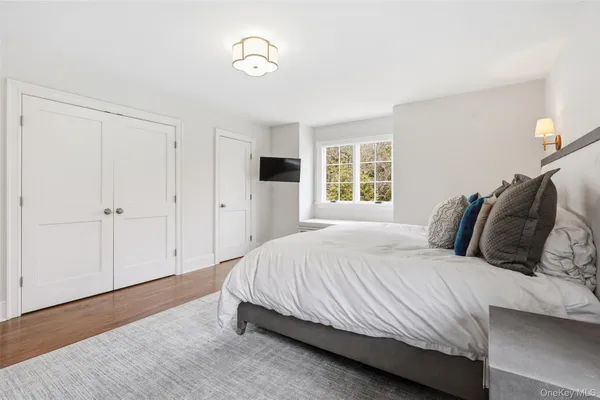 a bedroom with a large bed and a window