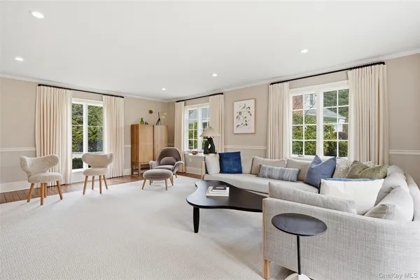 a living room with furniture and large windows