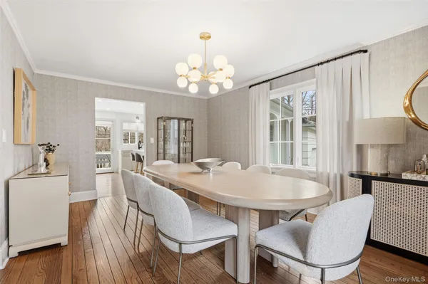 a view of a dining room with furniture wooden floor and chandelier