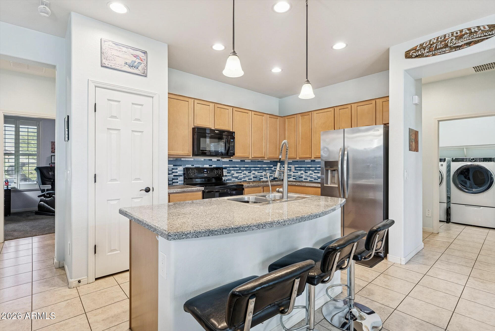 16632 South 175th Drive Goodyear, AZ 85338 - Photo 3 of 22 a kitchen with stainless steel appliances granite countertop a refrigerator a stove and a sink with granite countertops