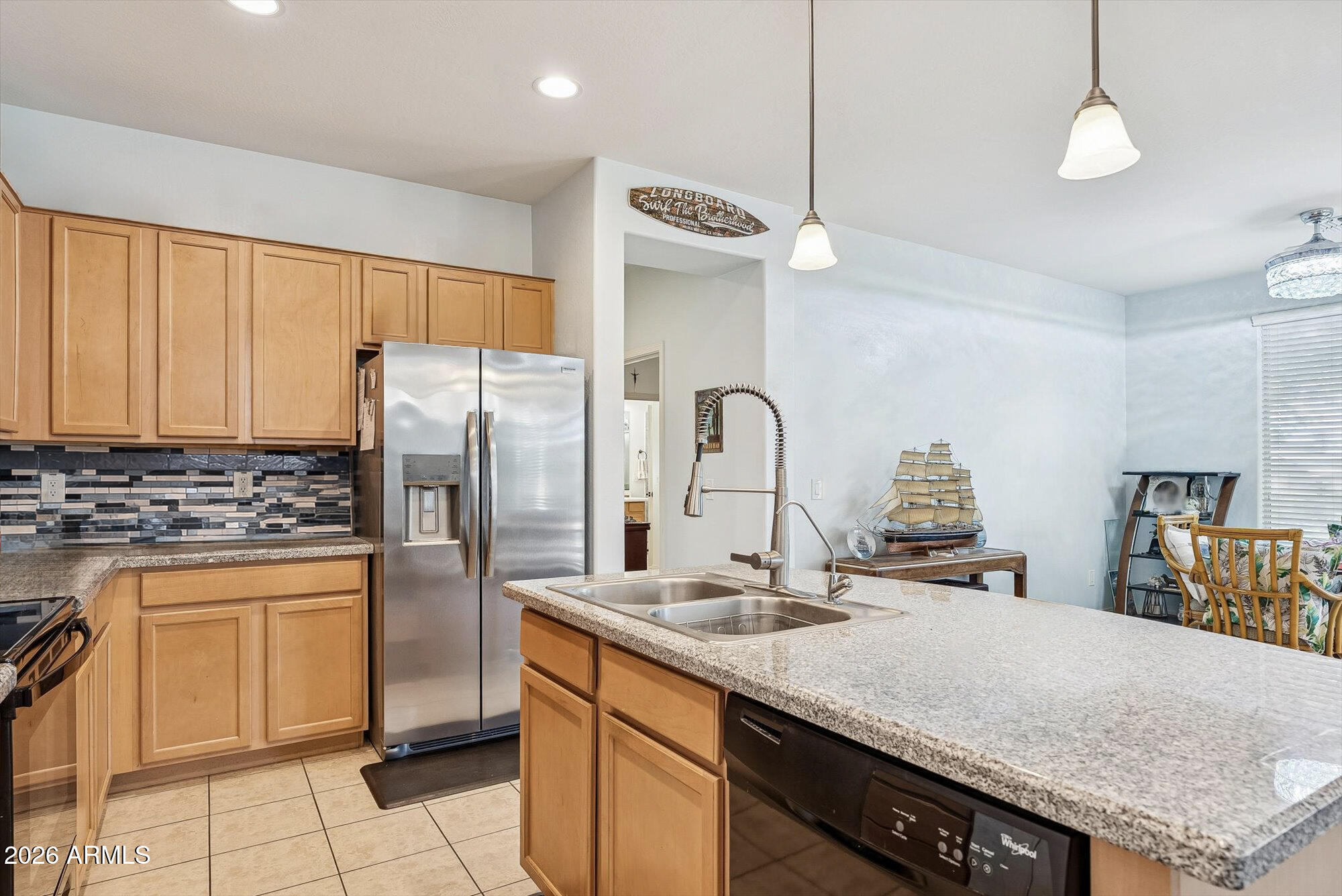 16632 South 175th Drive Goodyear, AZ 85338 - Photo 4 of 22 a kitchen with stainless steel appliances granite countertop a sink a stove and a refrigerator