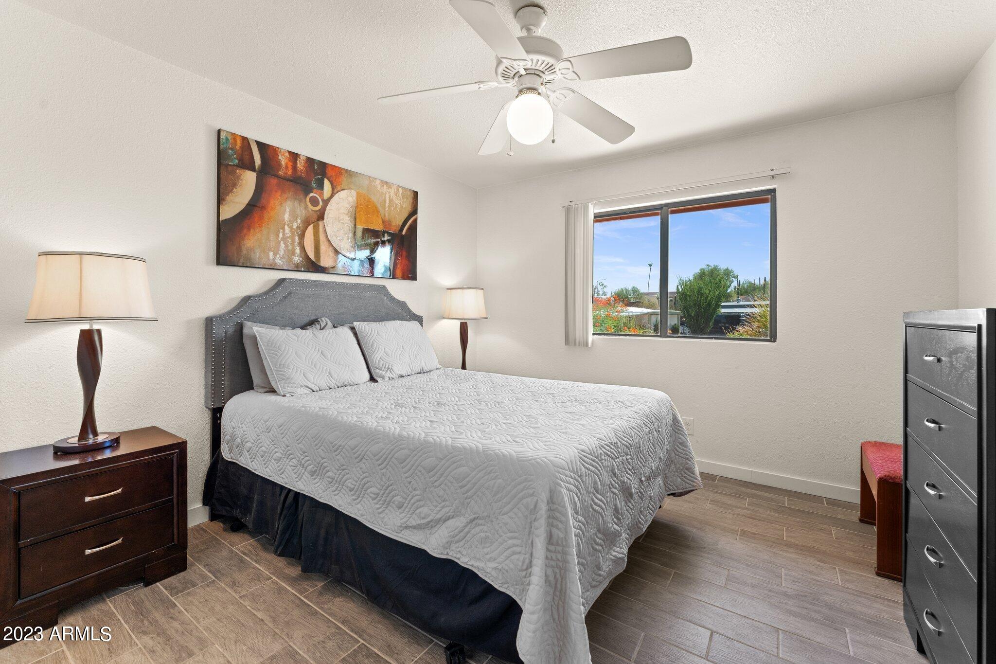 540 South West Road, Unit 26 Wickenburg, AZ 85390 - Photo 5 of 14 a bedroom with a bed and a chandelier