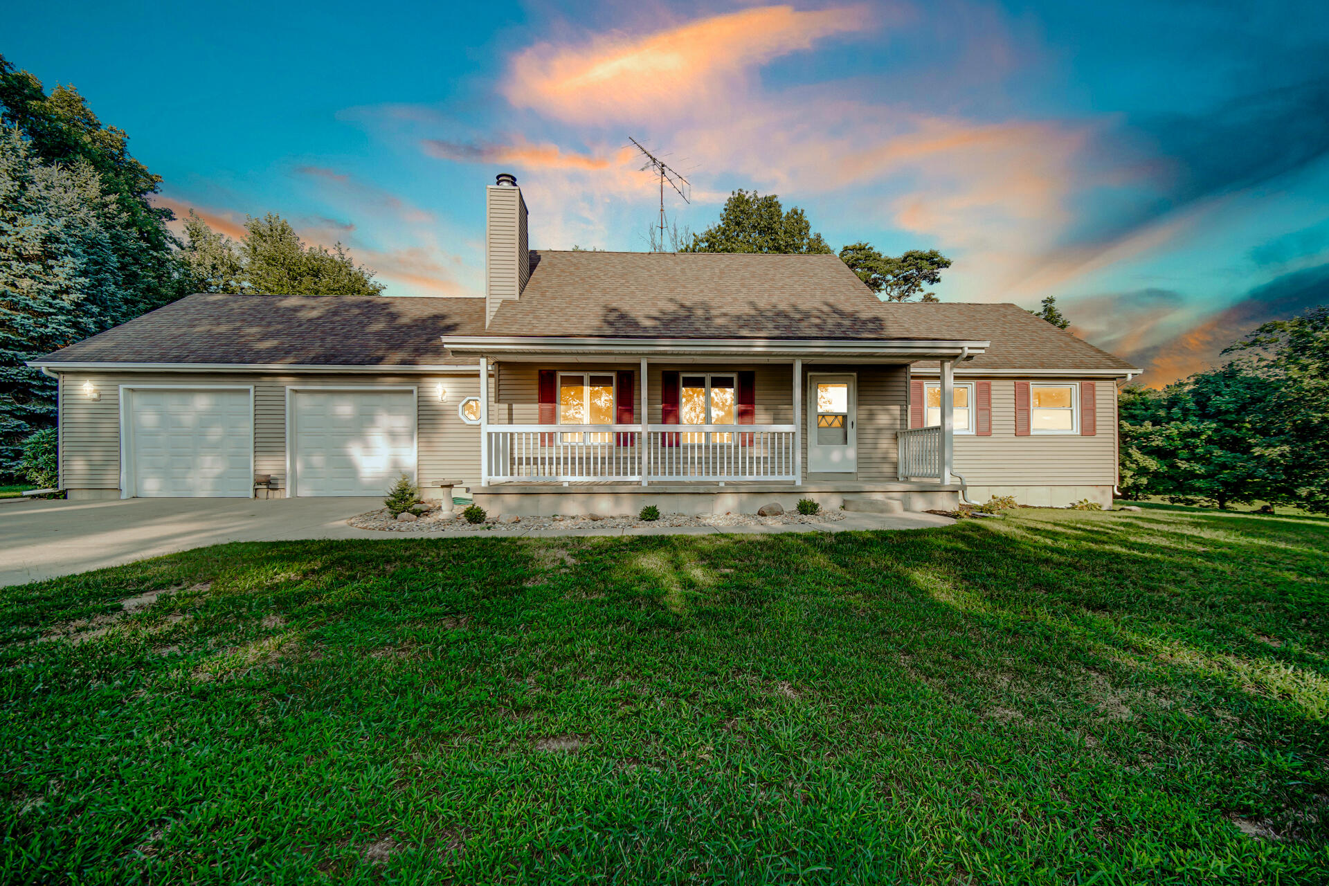 a front view of house with yard and green space