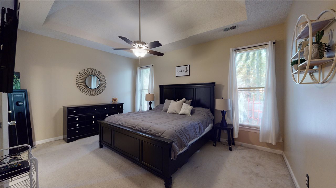 719 Gable Lane Collierville, TN 38017 - Photo 12 of 25 a bedroom with a bed chandelier and a window