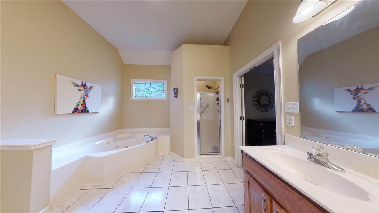 719 Gable Lane Collierville, TN 38017 - Photo 13 of 25 a bathroom with a tub sink and shower
