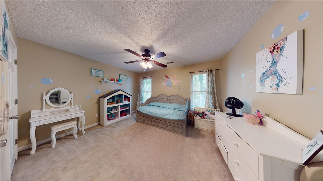 719 Gable Lane Collierville, TN 38017 - Photo 14 of 25 a bedroom with furniture and a chandelier