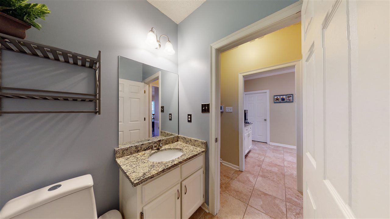 719 Gable Lane Collierville, TN 38017 - Photo 19 of 25 a bathroom with a granite countertop sink and a mirror